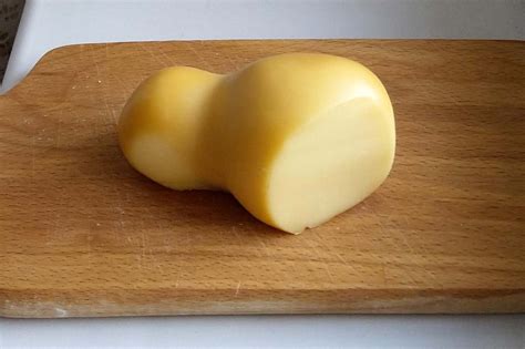Primo piano di una scamorza affumicata, mostrando la sua crosta brunita e la forma a pera