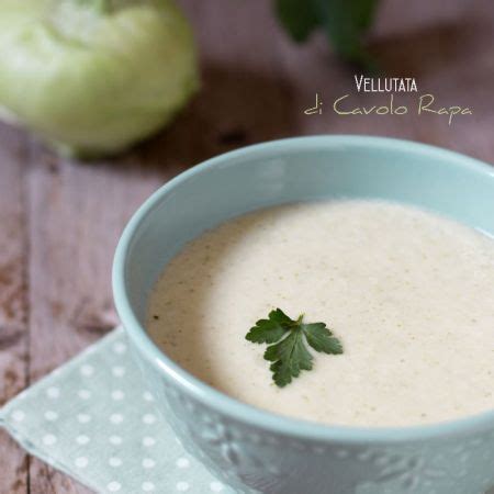Immagine di un piatto di vellutata di cavolo rapa e zucchine, guarnita con pepe rosa e un filo d'olio