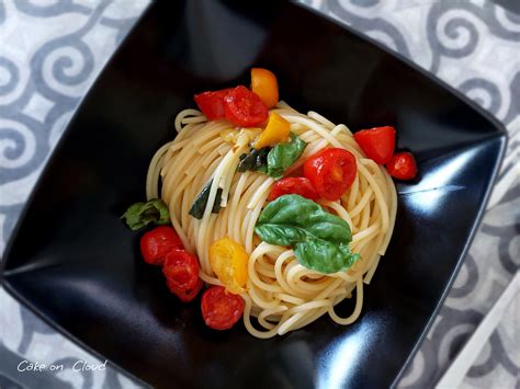 Immagine di spaghetti al peperoncino con pomodorini gialli e cipollotto.