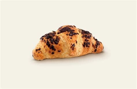 dettagli visivi di un croissant perfetto: colore esterno nocciola, interno giallo chiaro, puntini neri di vaniglia