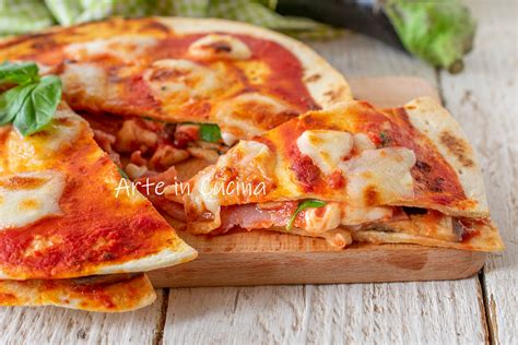 Primo piano di una piadipizza appena sfornata, con pomodorini freschi, rucola e mozzarella filante.