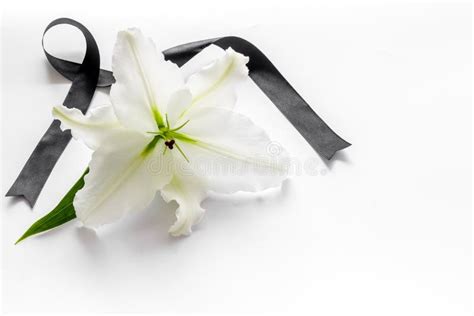 un'immagine simbolica di lutto, magari un nastro nero o fiori bianchi