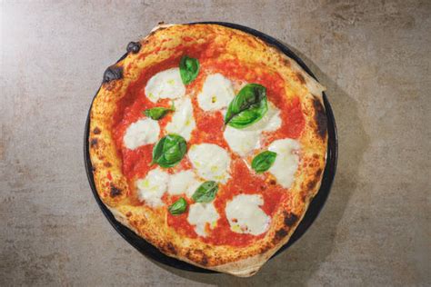 Pizza Margherita in teglia appena sfornata, con mozzarella filante e basilico fresco