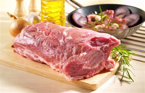 Spalla di maiale tagliata a pezzi per la cottura delle carnitas.