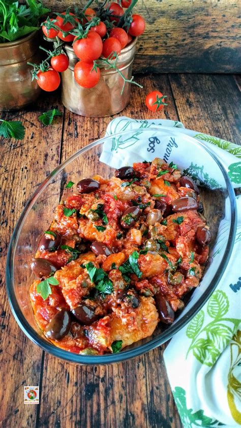 Focaccine pronte per la cottura, guarnite con pomodoro, olive e cipolla.