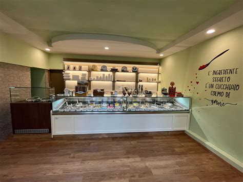 Interno di gelateria con colori caldi, legno antico e laboratorio a vista
