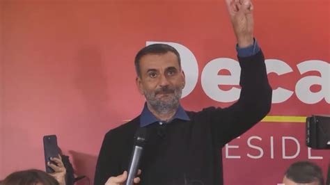 Il Sindaco Antonio Decaro in tenuta sportiva, sorride mentre tiene un pallone da calcio.