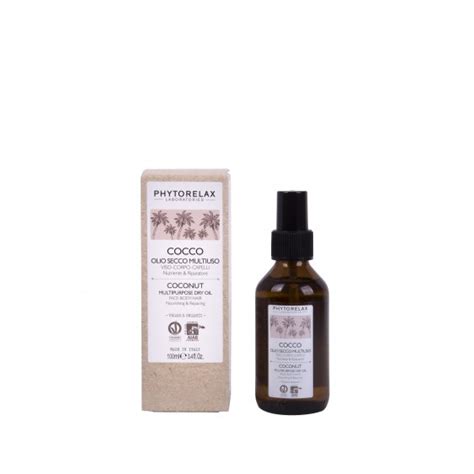 Bottiglia di olio di cocco Phytorelax con ingredienti naturali in sottofondo