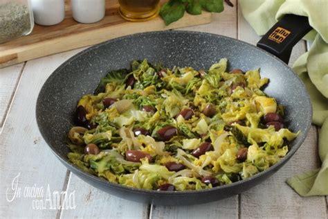 padella con olive nere che friggono nell'olio con aglio e peperoncino