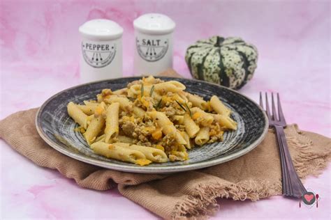 Salsiccia sbriciolata che cuoce in padella con la zucca